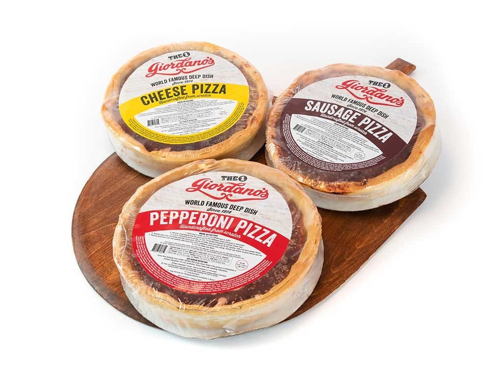 Packaged Giordano's cheese, sausage and pepperoni pizzas on a wooden board