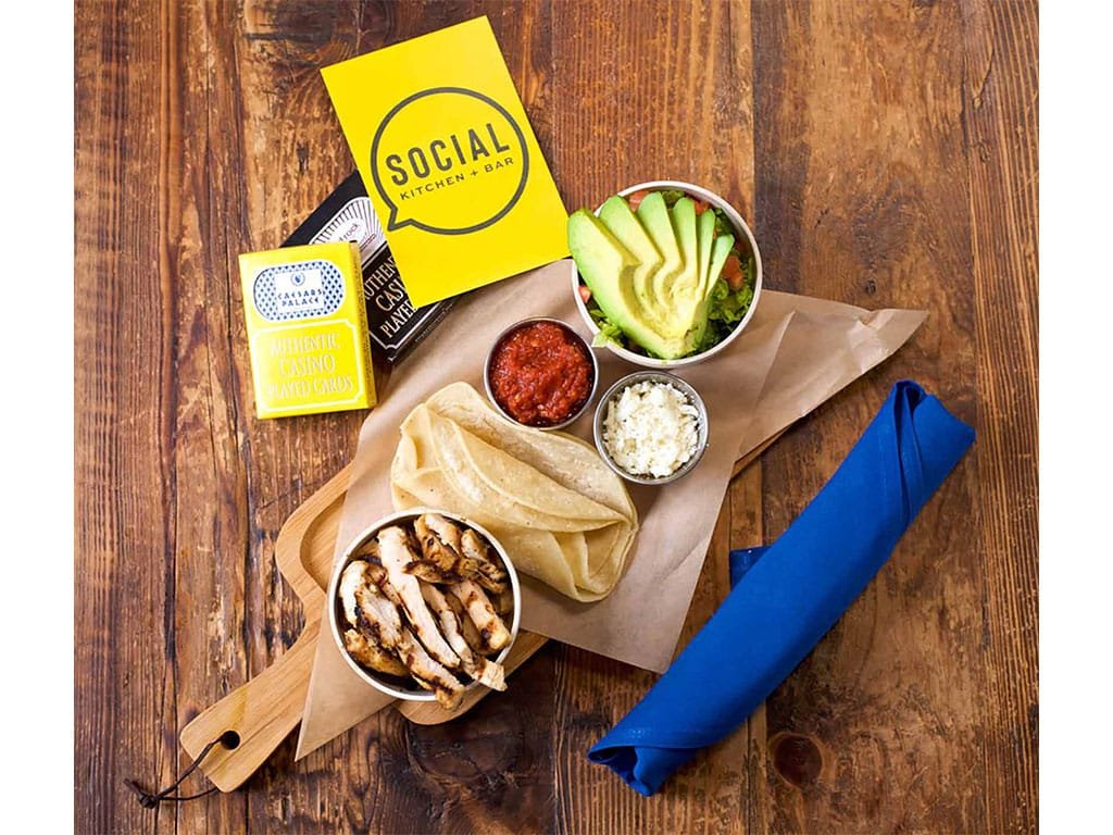 Social branded taco kit with tortillas and toppings on a wooden table
